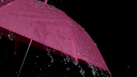 rain falling on pink umbrella