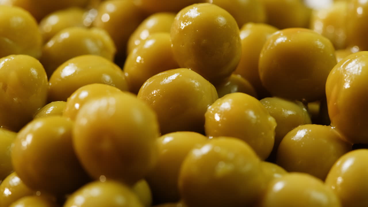 marinated pickled sweet green peas, rotation in circle. Take canned green pea kernels with a fork. High quality 4k footage