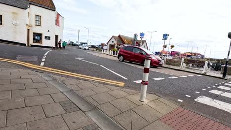 outdoor cafe view with passing pedestrians and cars