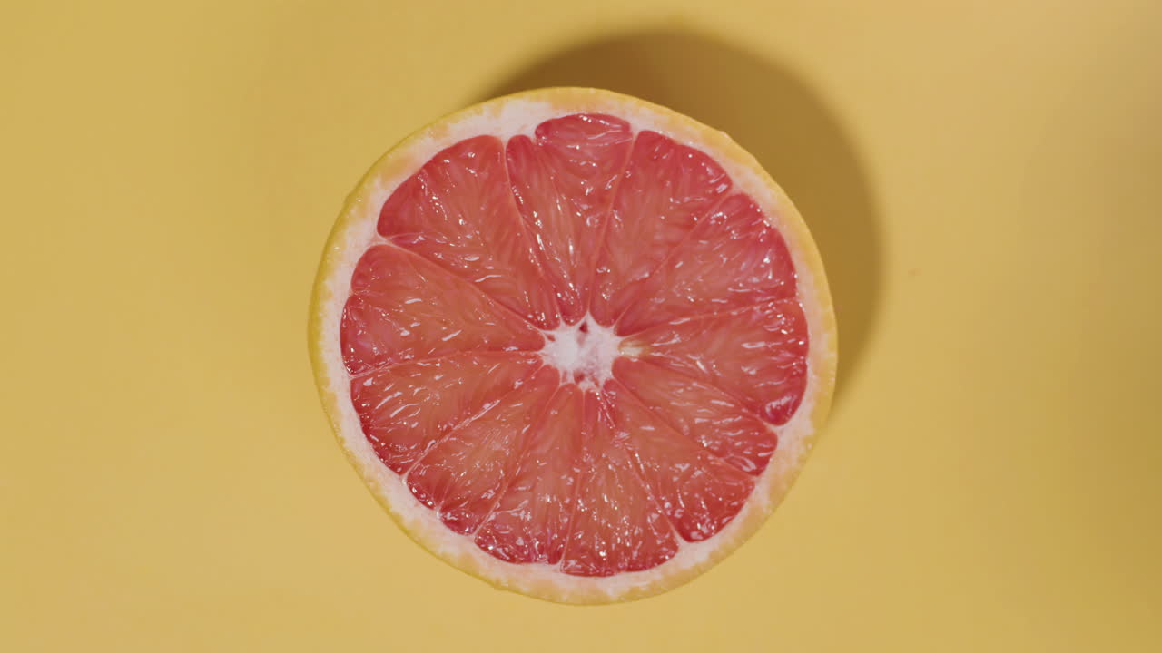 Top view shot of red orange on isolated yellow surface