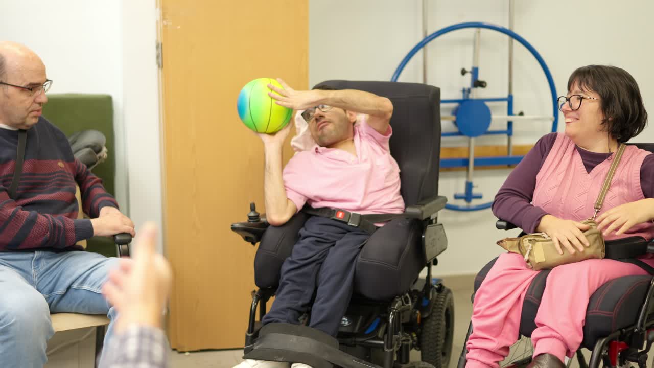 Happy Adults with Disabilities Playing Ball Game in Rehabilitation Center