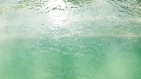 aerial top view of ocean blue waves breaking on a beach