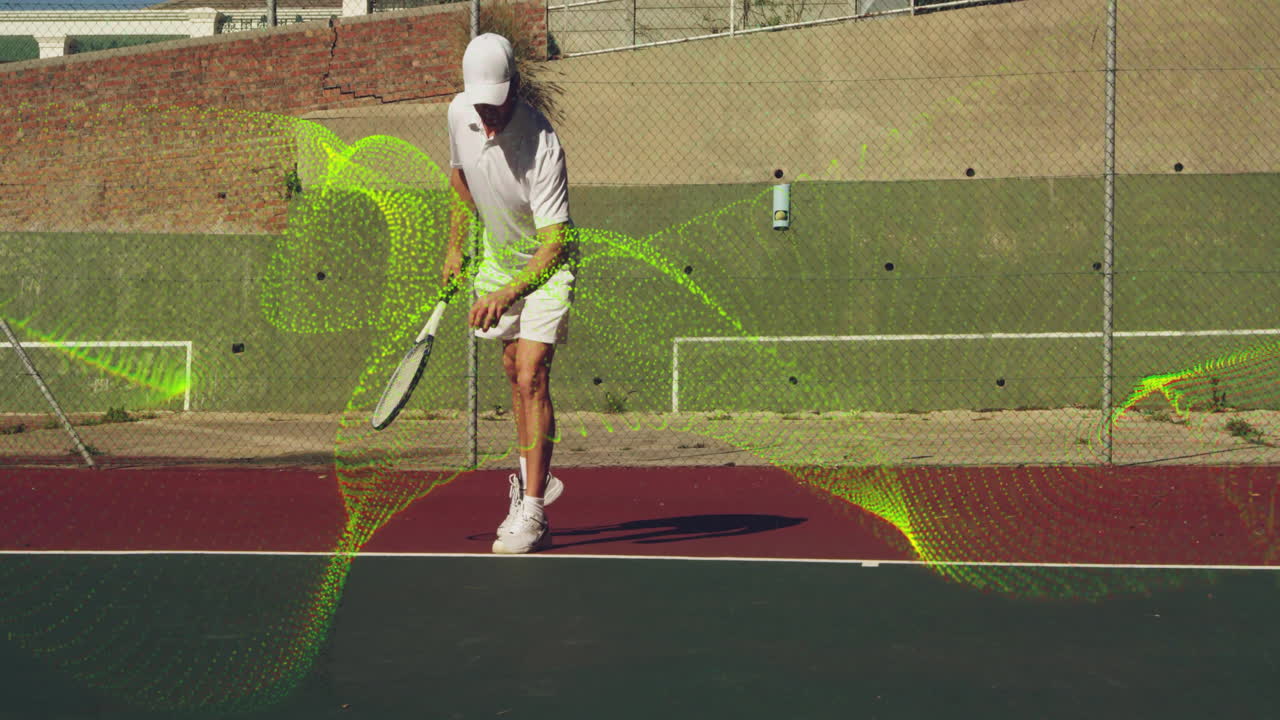 Male tennis player dribbling tennis ball on court showcasing sports tech via green digital overlays