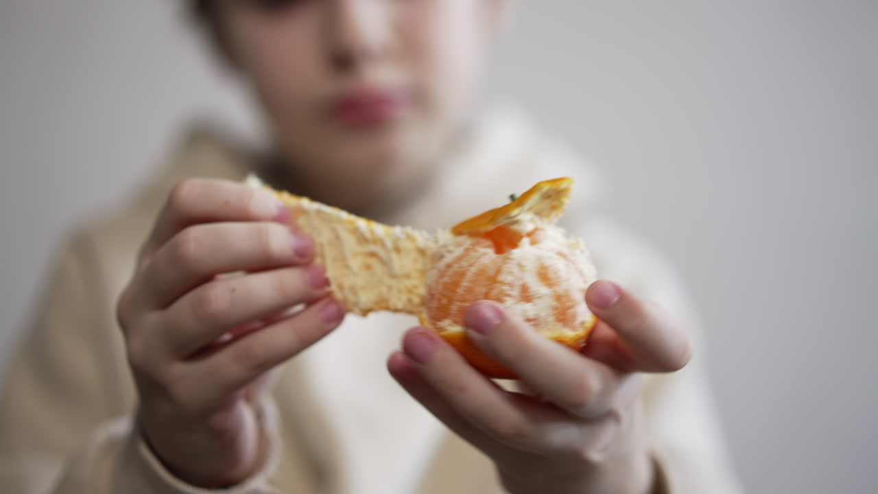 Child peeling an orange