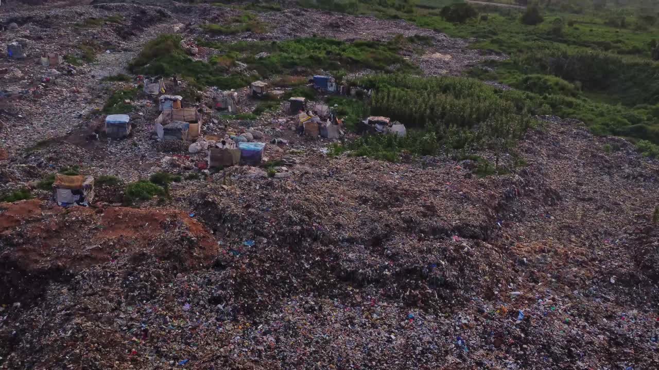 Jib down of a large landfill with large heaps of garbage in rural Nigeria