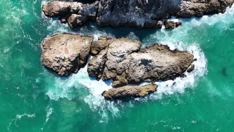 Top-down-ascending-shot-of-rocks-just-off-Stradbroke-Island-headlands