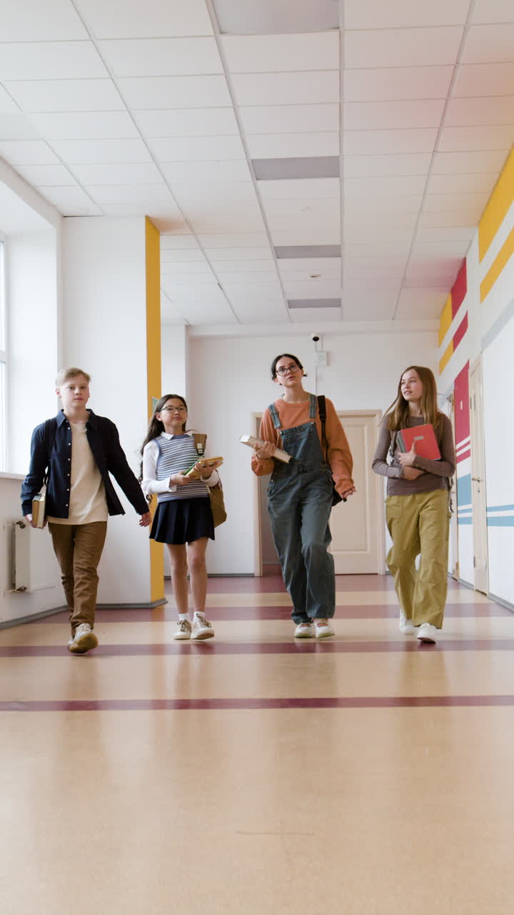 Students walking through a school hallway with books