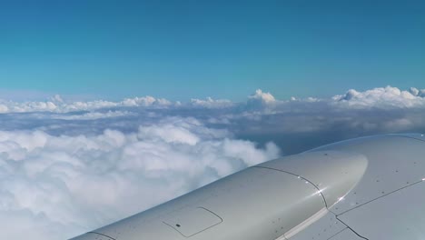 airplane travel flying through clouds looking out airplane window