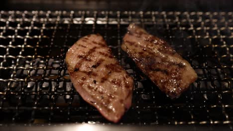 sizzling beef slices cooking on a hot grill