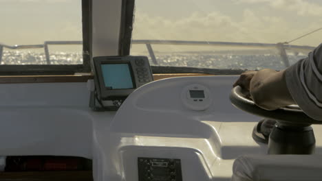 captain driving yacht in the sea