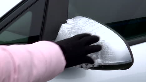 removing ice from a car mirror