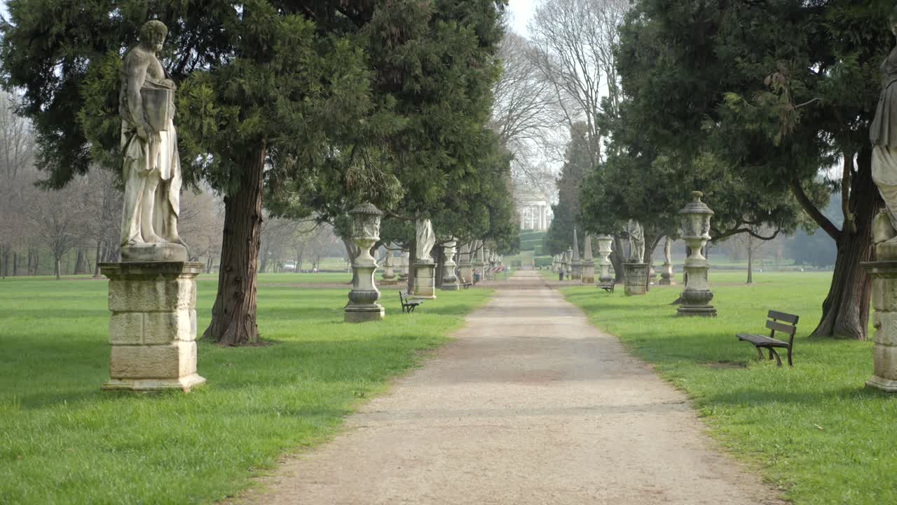 Serene Path Through a Formal Garden with Statues