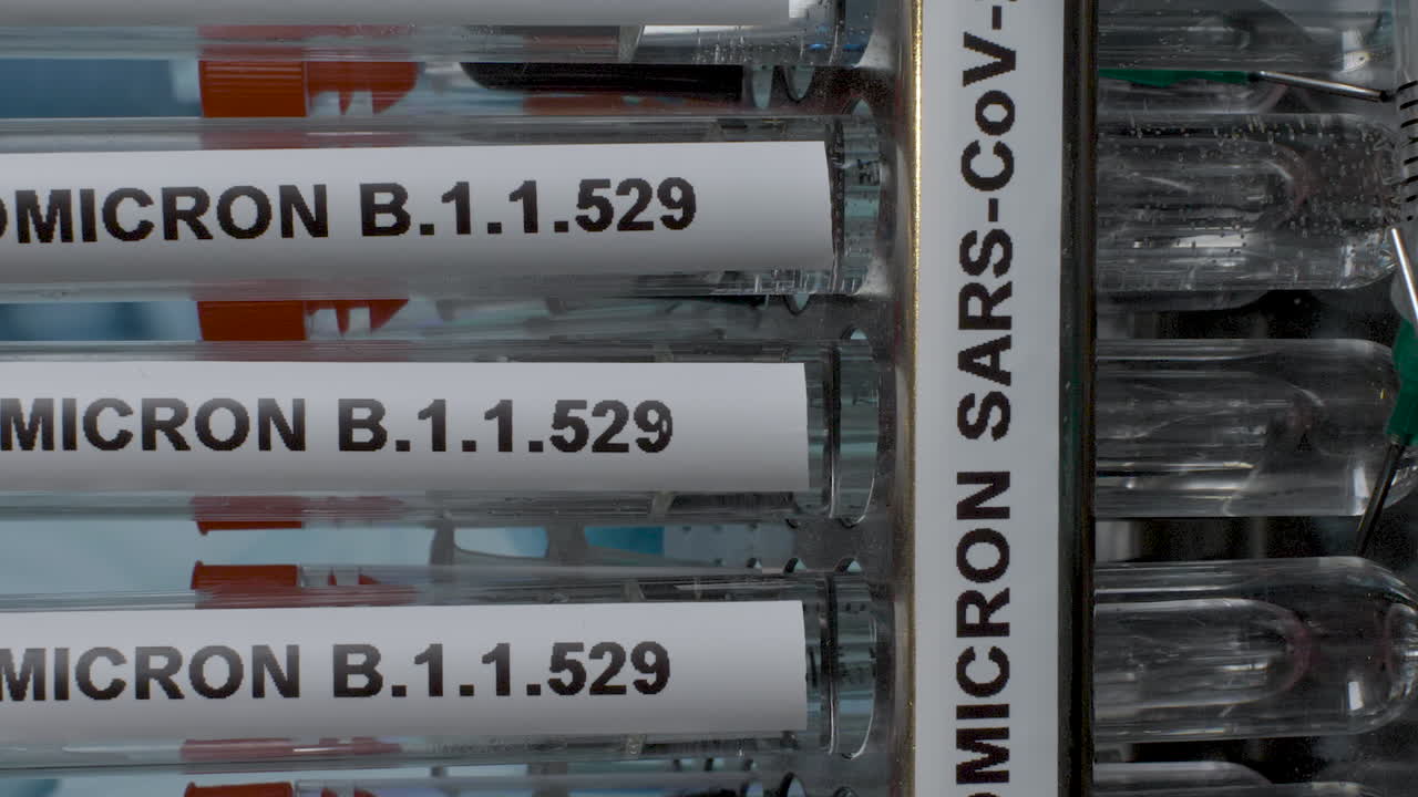 Vertical view of Research work going on in a lab checking the efficacy of covid vaccines in the market against the new strain B.1.1.529 with samples of it in the tube. Omicron rapidly spreading.