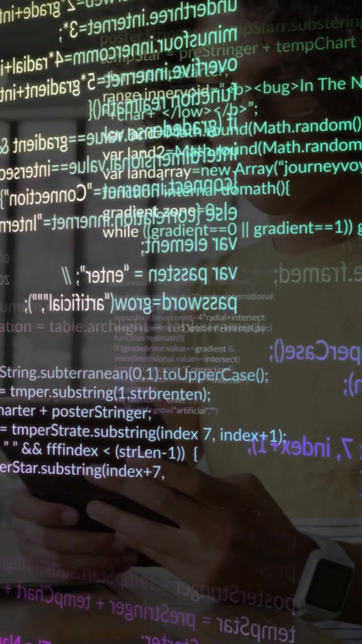 Tapping man in mustard tee, glasses scrolling phone at workspace, smartwatch and code overlays