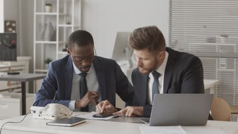 two male brokers working together at stock exchange company