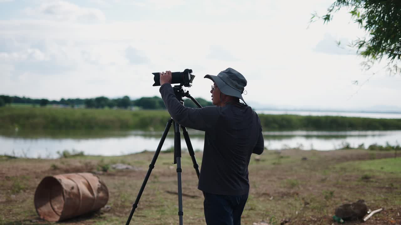 Photographer taking pictures of a lake landscape