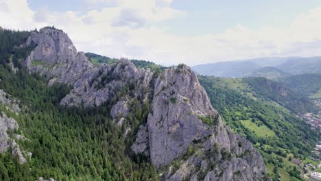 Karst-peak-in-landscape,-rotating-aerial-shot-during-sunny-day