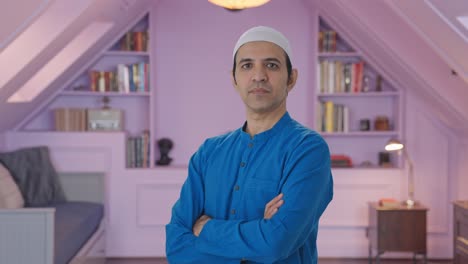portrait of confident muslim man standing crossed hands