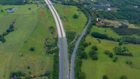 green meadow and hills surrounding the carriageways in byron bay, nsw, australia