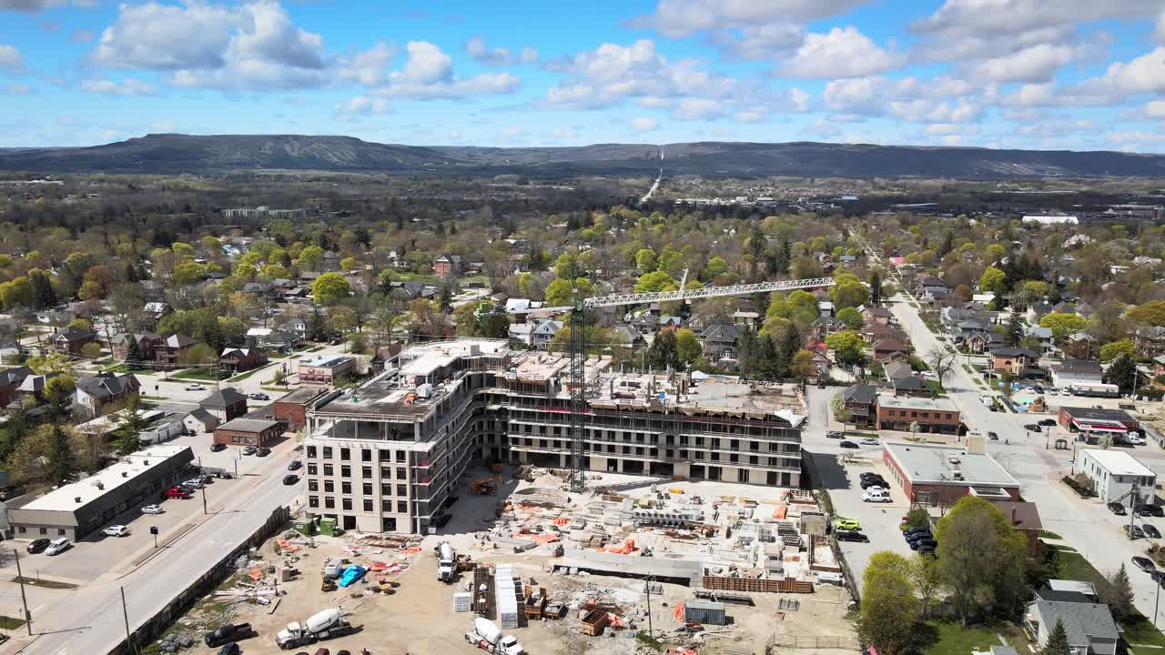 Aerial view circling over the construction site of an apartment building in Collingwood