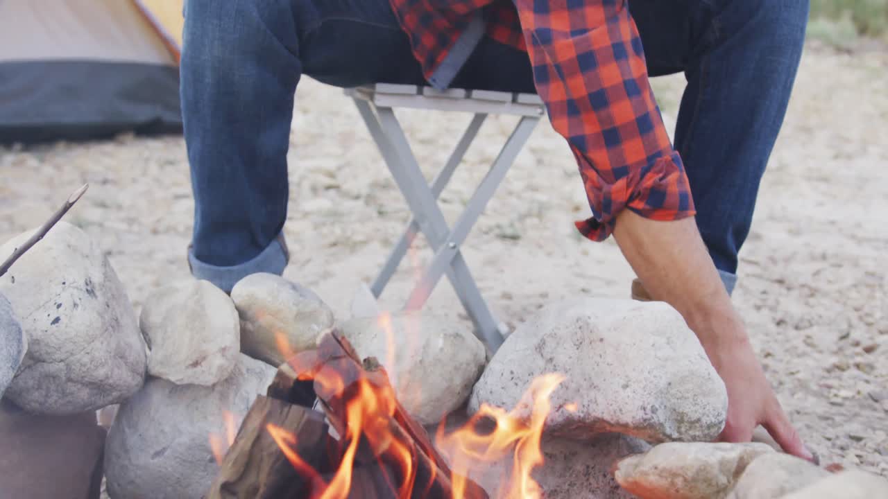 Caucasian man camping in nature.