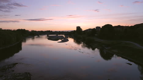 nice view of bridge over ticino river in pavia at sunset, lombardy, italy, shot at 30 fps