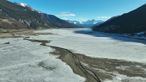 low level of frozen water in lago di resia on a cold winter day