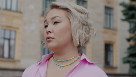 woman in pink shirt, city portrait
