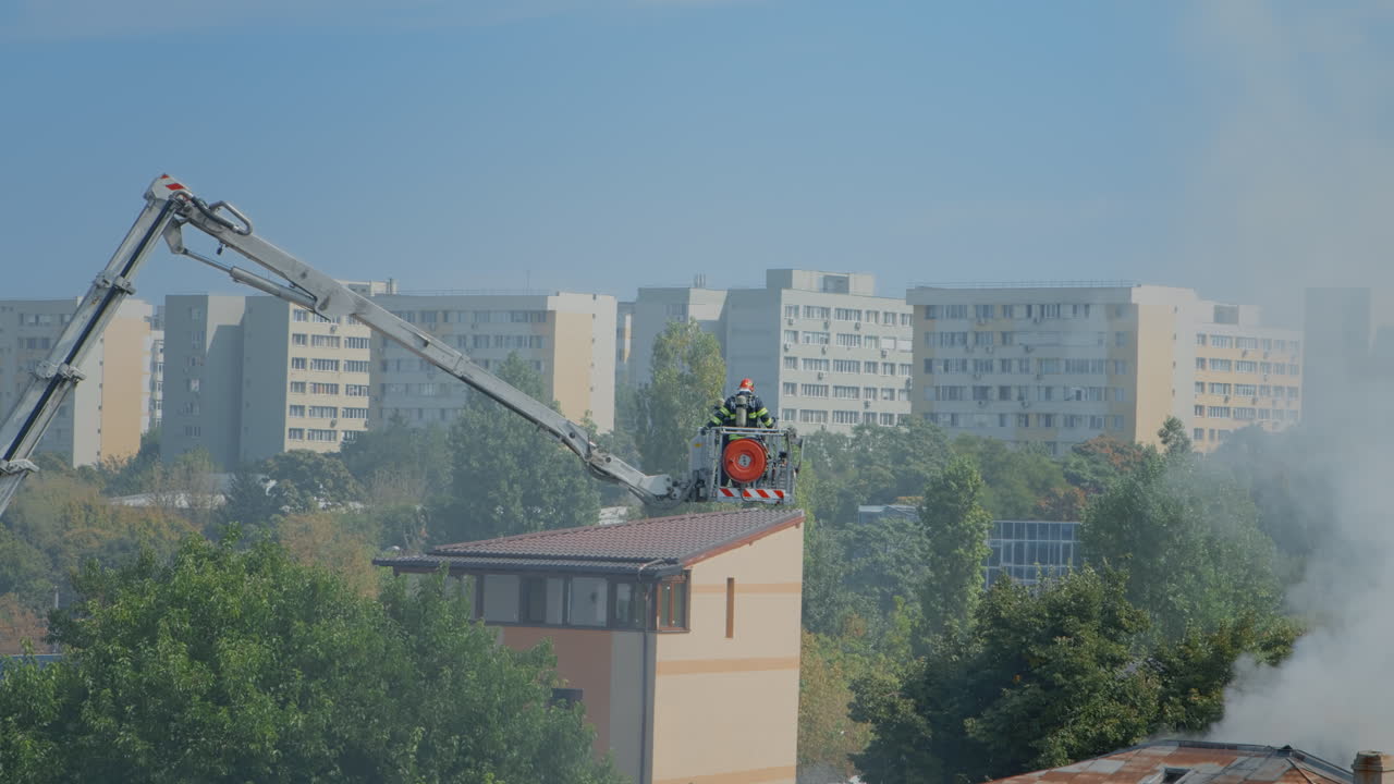 View of firemen using platform truck from fire department