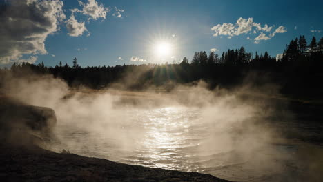sunburst over steaming geothermal pool