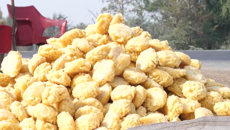 pile of jaggery lumps on sale on roadside in punjab