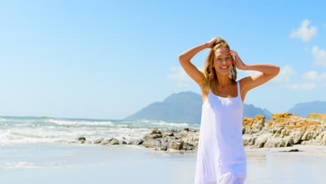 front view of young caucasian woman standing at beach 4k