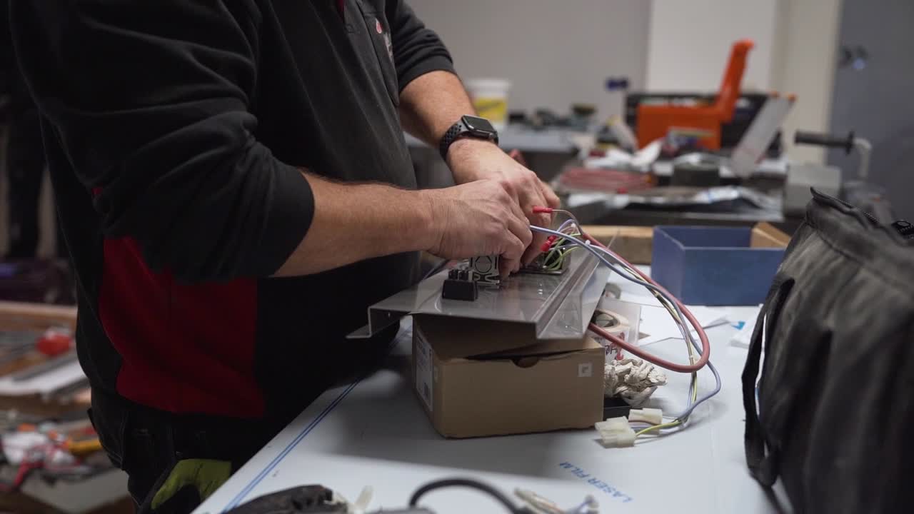 Slowmotion view of a professional working on electronics in an indoor workshop