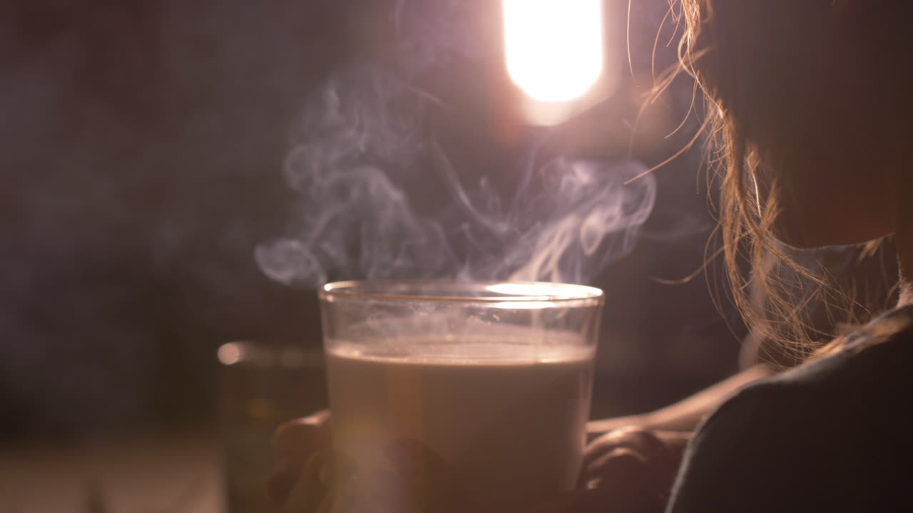 Little girl child blowing scented candle out, smoke coming out. Close up side