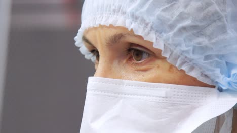 Laboratory-worker-face-in-protective-mask-looking-away.-Doctor-face-in-mask