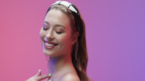 portrait of smiling caucasian woman with blond hair touching her neck, copy space, slow motion