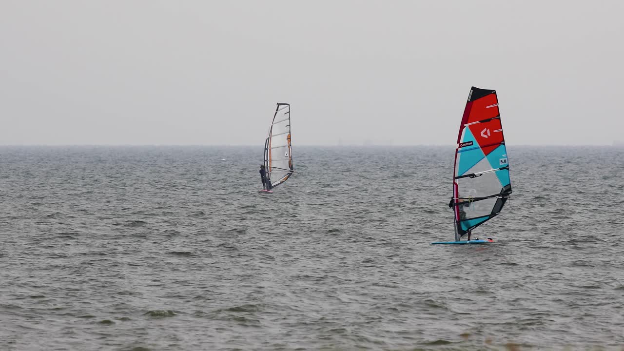 Wind Surfing off the Coast of Pattaya in Thailand on an Overcast Day. Extreme Recreational Sport Activity