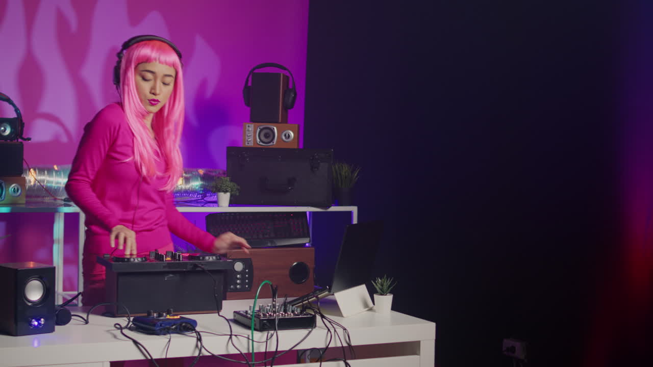 DJ mixing music with turntable and sound system