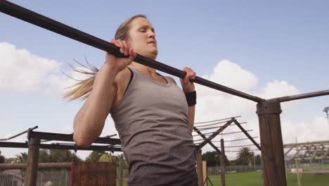 Young woman training at an outdoor gym bootcamp