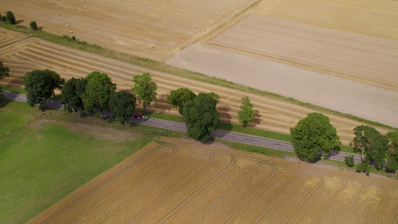 트랙터는 트레일러에서 곡물을 운반하고, 도로에서 운전하고, 공중 추적 보기