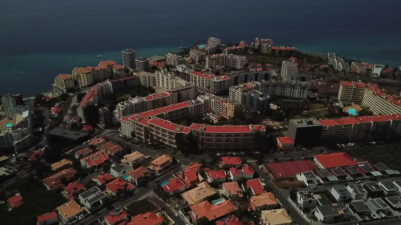 Fly over Funchal's hotel area with stunning aerial footage of the city's luxurious accommodations and beautiful sea views