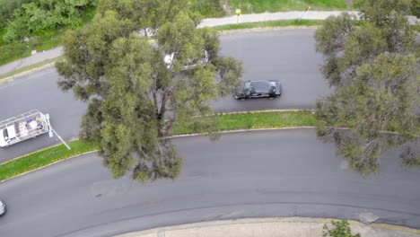 Top-Down-of-Cars-and-Motorcycles-Passing-on-Curved-Road