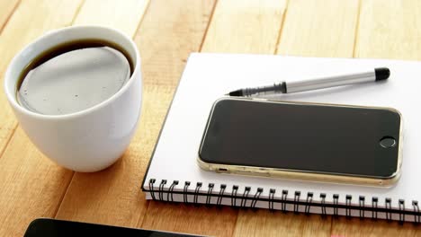 digital tablet, coffee, diary, mobile phone, pen and sticky notes