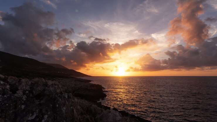 Sunset over the ocean with dramatic clouds