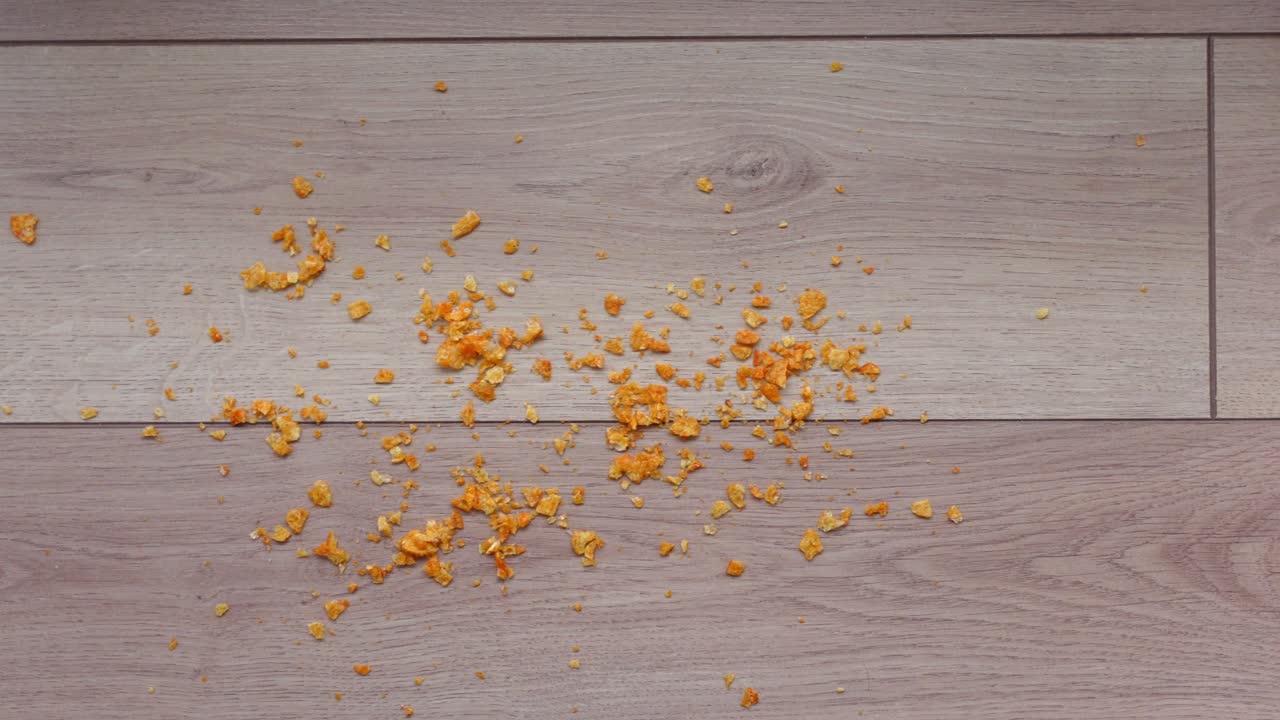 Orange Crumbs on Light Brown Wooden Floor
