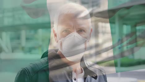 animación de la bandera de nigeria ondeando sobre un hombre caucásico con máscara facial en la calle de la ciudad