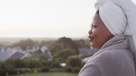 african american plus size woman drinking tea on balcony, unaltered, copy space, slow motion
