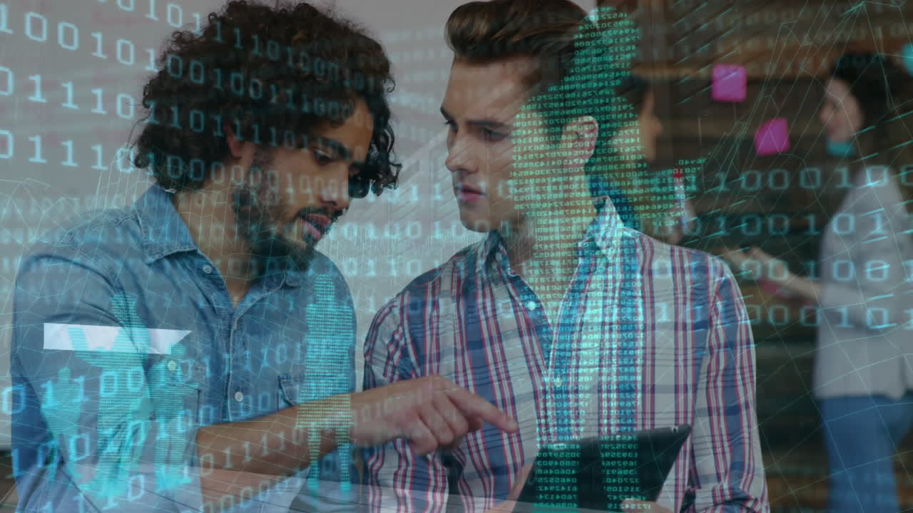 Two male colleagues collaborating on tablet in office displaying technology binary network overlay