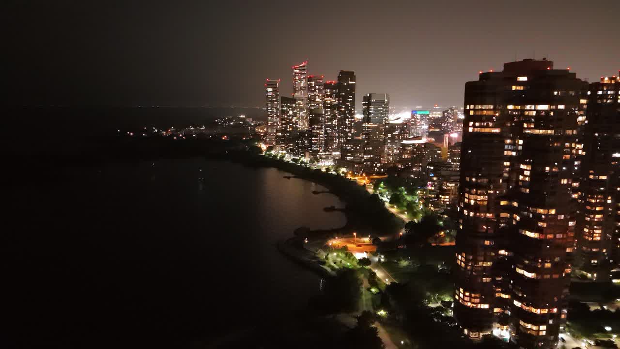 High-rise Skyline At Night In Stonegate-Queensway Neighbourhood By Lake Ontario In Toronto, Ontario, Canada. - aerial shot