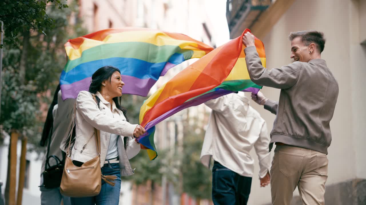 People celebrating LGBTQ pride with a rainbow flag